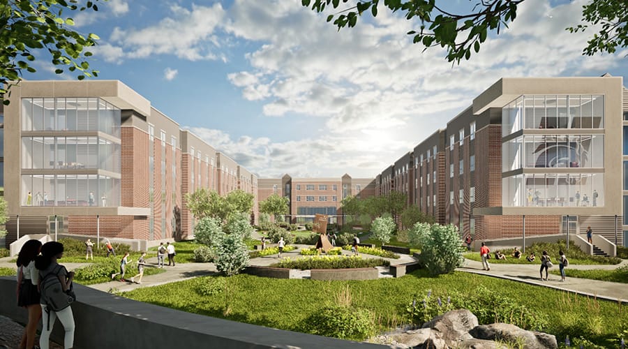 Photo of the courtyard of a new residence hall, the 1882. Brick and glass structure, with grass and trees in the courtyard.