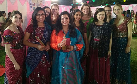 Suzette Escamilla Morales (second from left) stands among her classmates dressed in traditional Indian dresses for a Garba dance. moralesgarba edit